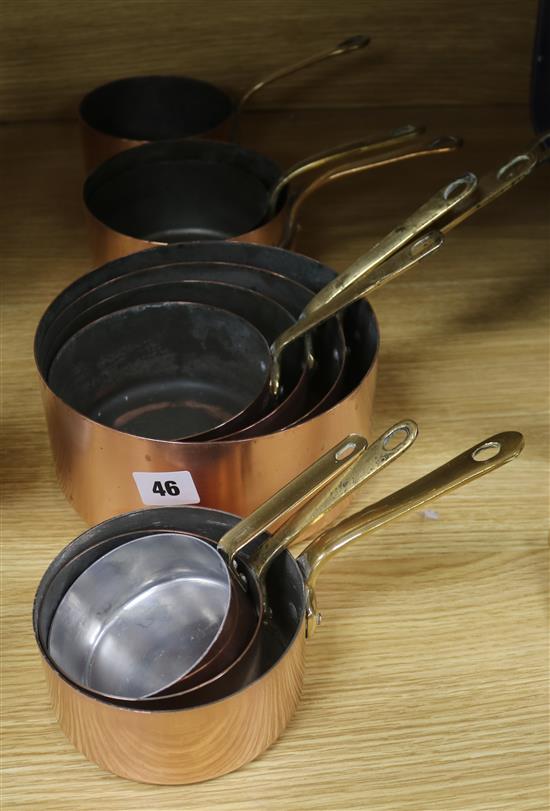 Ten brass handled 19th century French graduated saucepans